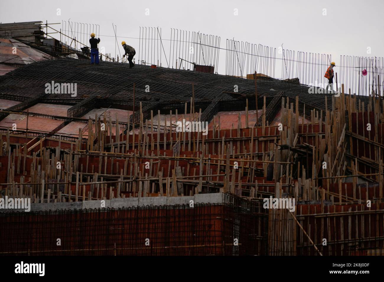 Workers work at a construction site, following the coronavirus disease (COVID-19) outbreak, in Shanghai, China, October 14, 2022. REUTERS/Aly Song Stock Photo