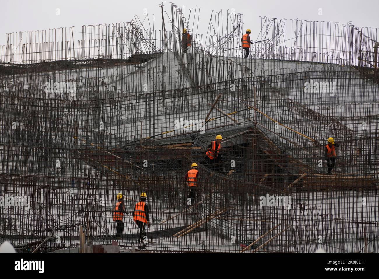 Workers work at a construction site, following the coronavirus disease (COVID-19) outbreak, in Shanghai, China, October 14, 2022. REUTERS/Aly Song Stock Photo