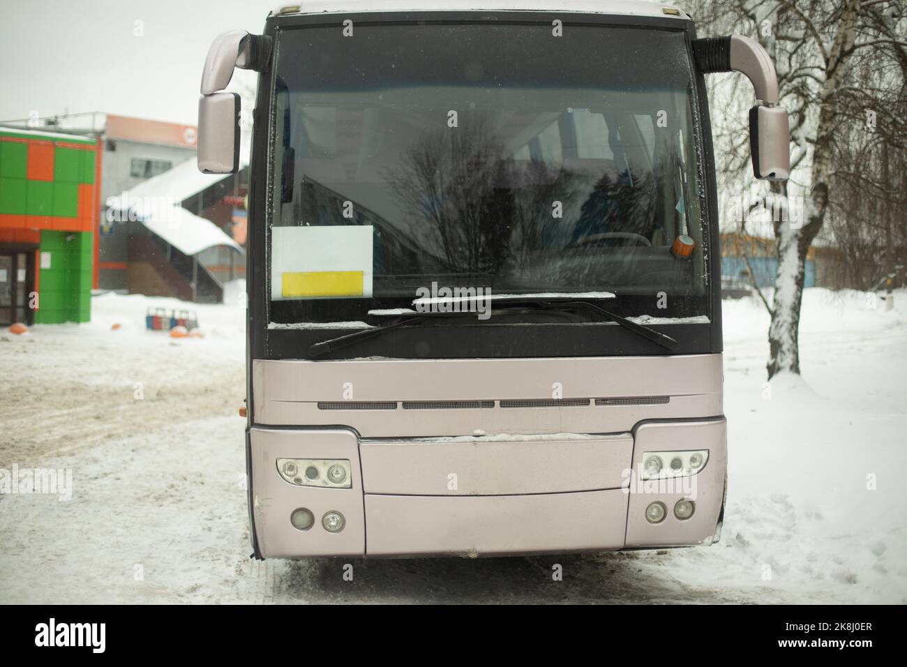 Bus in parking lot. Transport in winter. Public transport in city. Car windshield. Stock Photo
