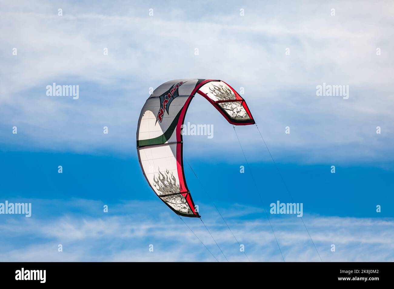 Kite-surfing against a blue sky. Kites in the sky. Holidays on nature. Close-up one kitesurf wings kite equipment fly against clear sky. Active travel Stock Photo