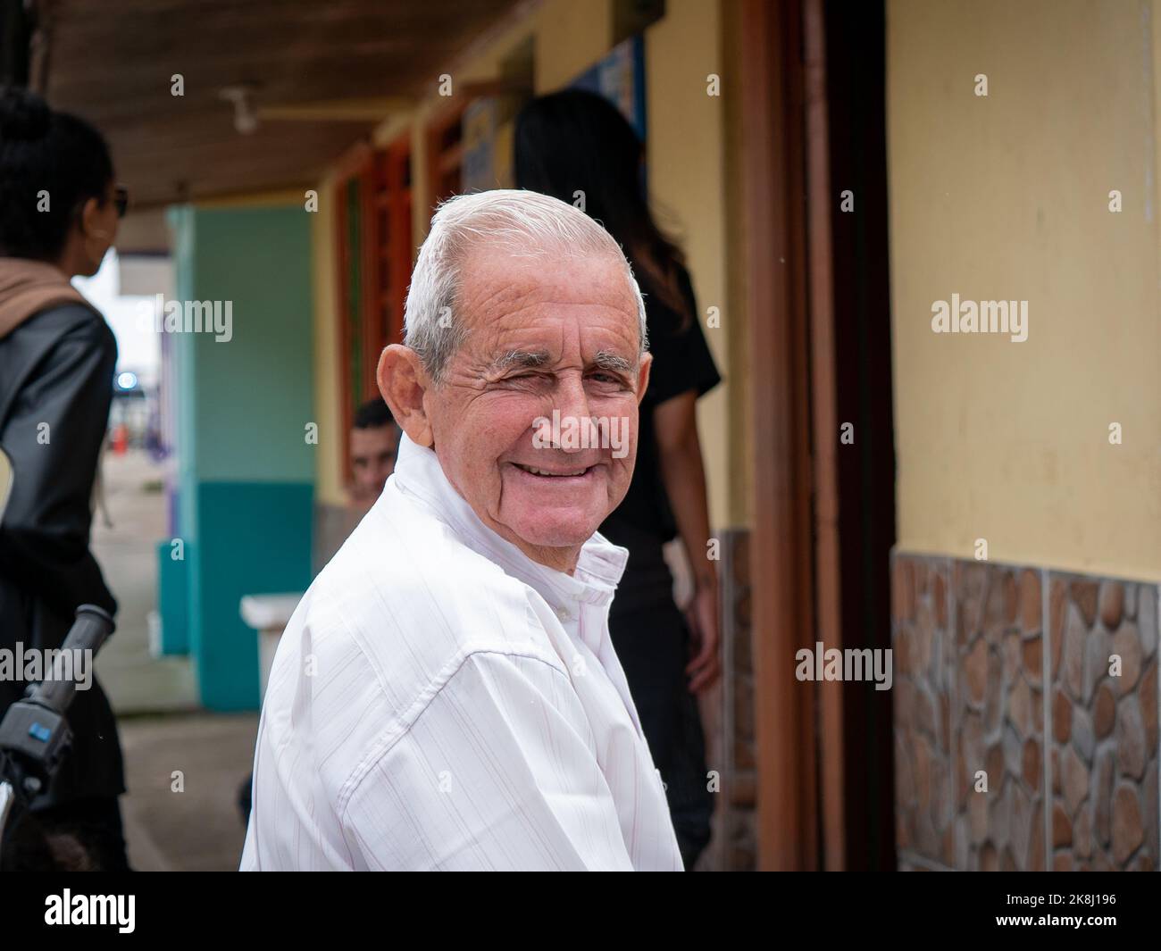 Filandia, Quindio, Colombia - June 5 2022: Older White-Haired Man Smiles at the Camera and Winks Stock Photo