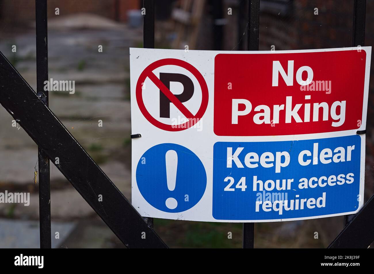 No Parking sign and symbols on a steel fence with soft focus background Stock Photo