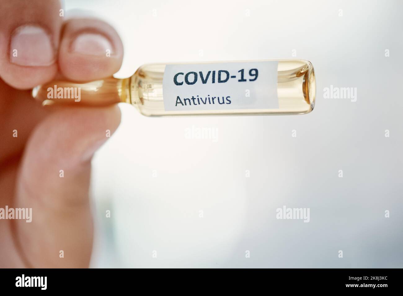 The official game changer. a scientist holding an ampoule with 2019-nCov on it. Stock Photo