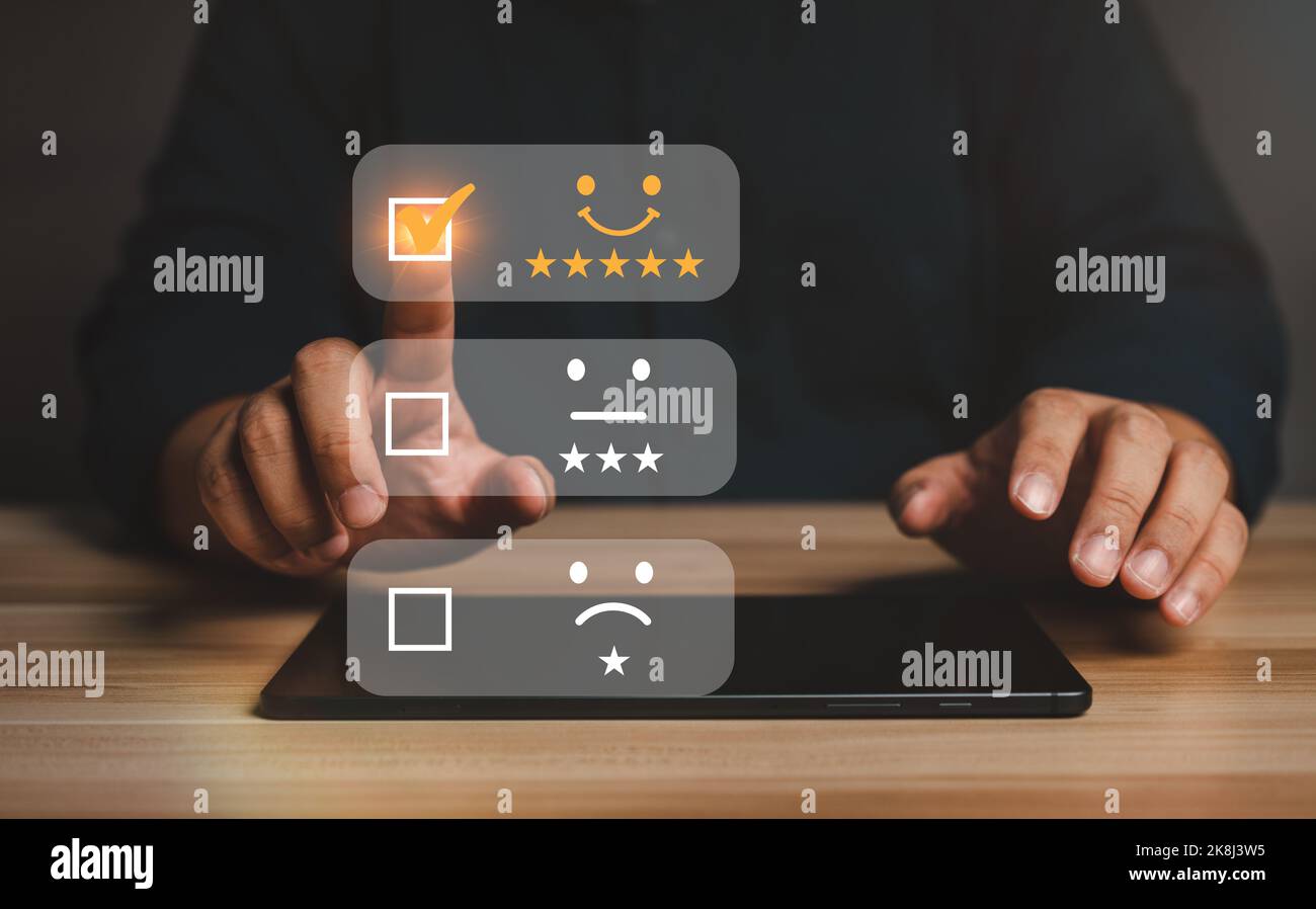 Businessman gives ratings to service experience on a smartphone, Service Provider Satisfaction Ratings and Evaluations,  Satisfaction concept and Cust Stock Photo