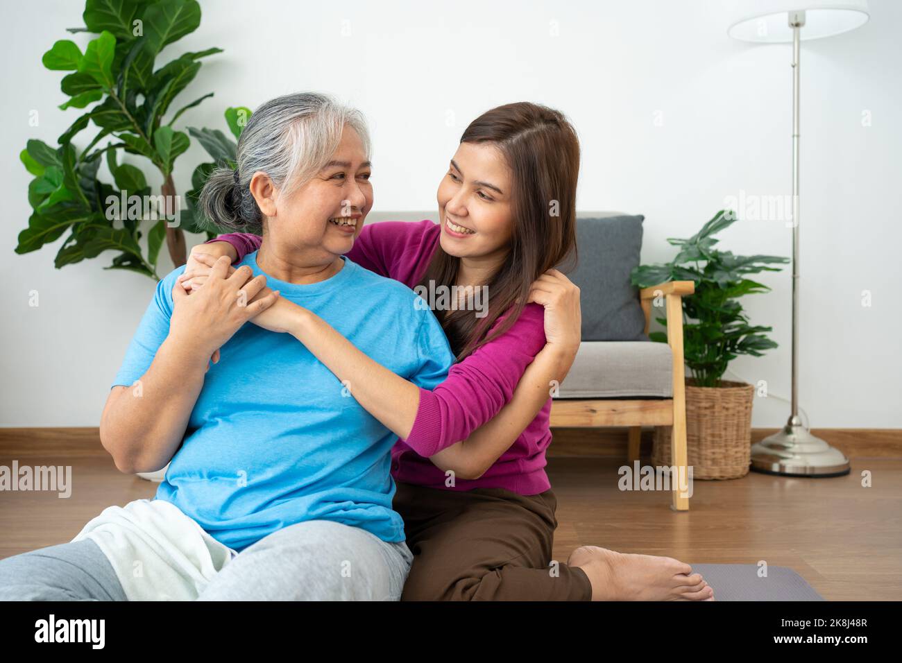 Asian careful caregiver or nurse taking care of the patient in a home.  Concept of happy retirement with care from a caregiver and Savings and senior Stock Photo