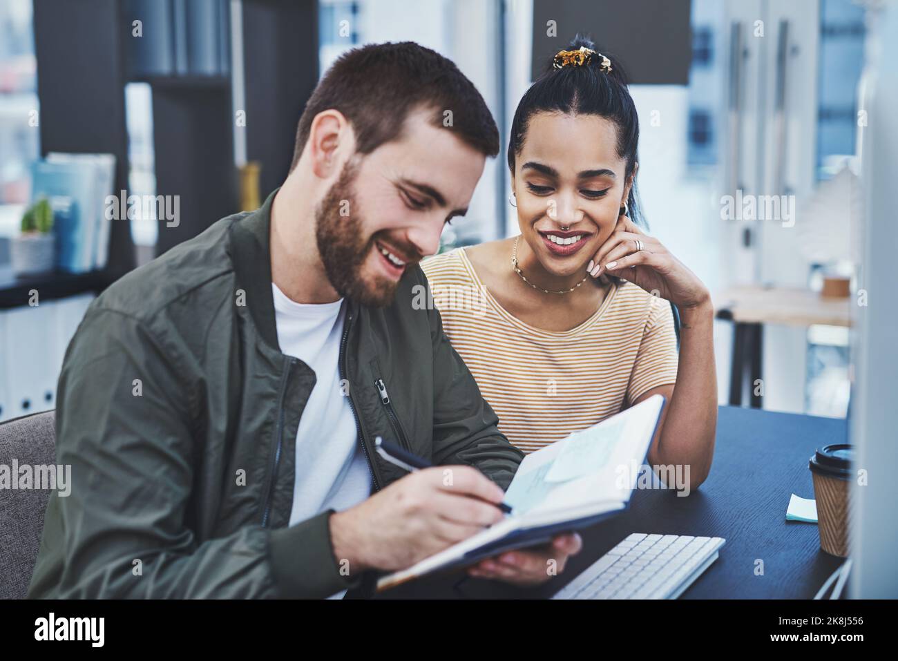 Building on a solid creative strategy. two young designers working together in an office. Stock Photo
