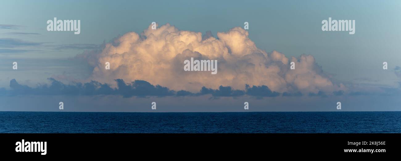 Panoramic skyline with magnificent clouds seen over the ocean. Stock Photo