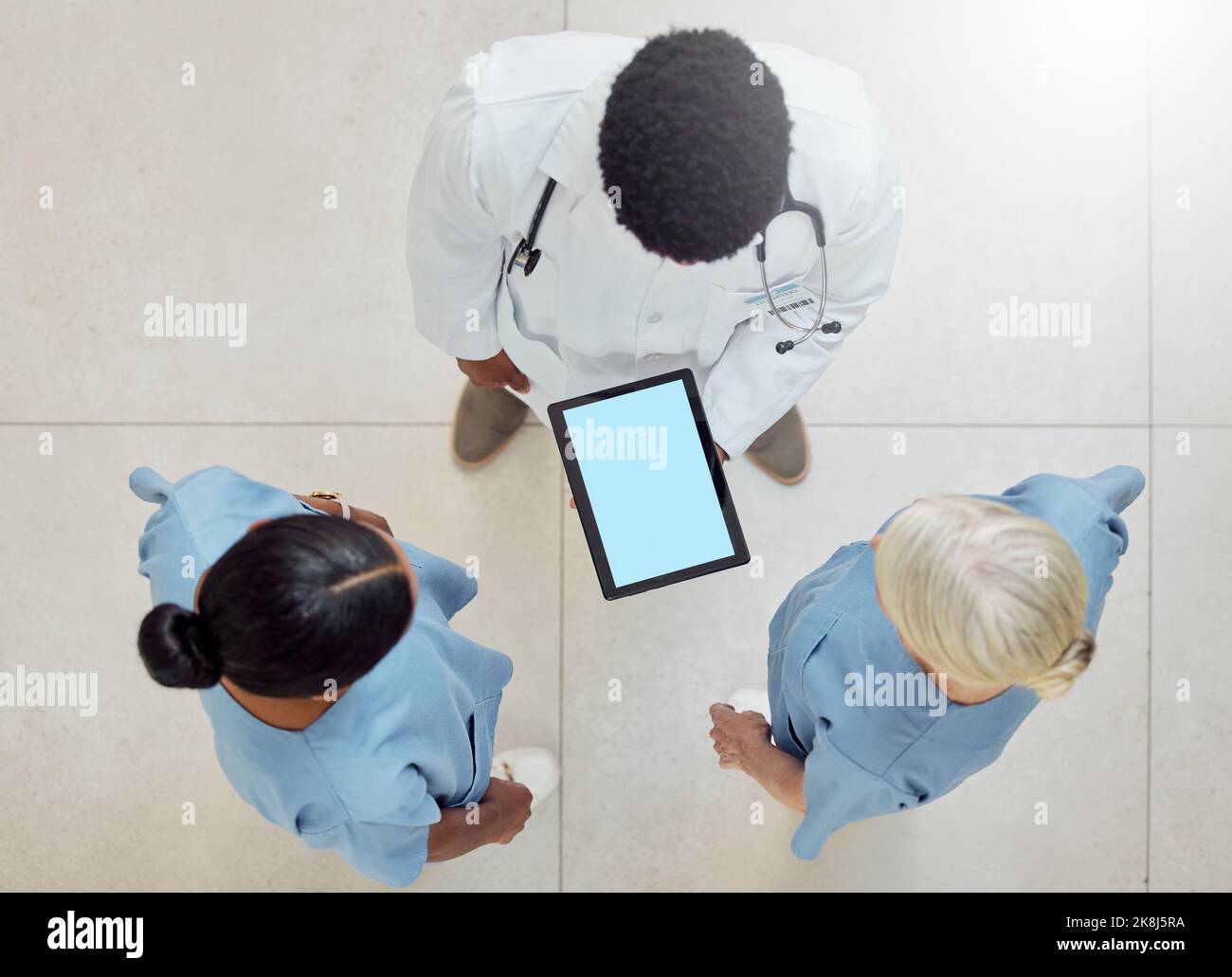 Topview of doctors, tablet green screen and nurses mockup of hospital for patient healthcare with professional consultation. Digital health report Stock Photo