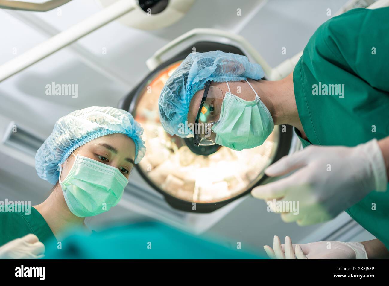 Low Angle Shot of Professional surgeons team performing surgery in operating room, surgeon, Assistants, and Nurses Performing Surgery on a Patient, he Stock Photo