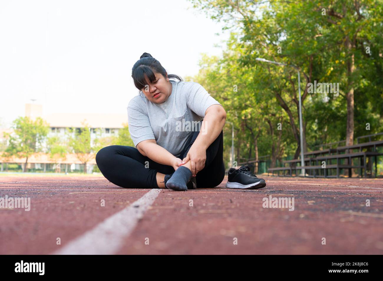 Asian overweight woman a new runner pain ankle during running, Athlete