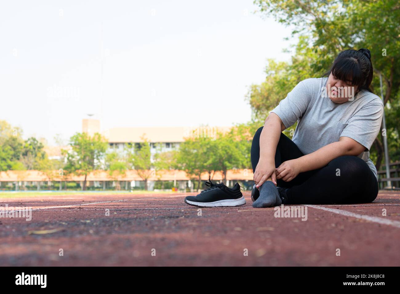 Asian overweight woman a new runner pain ankle during running, Athlete