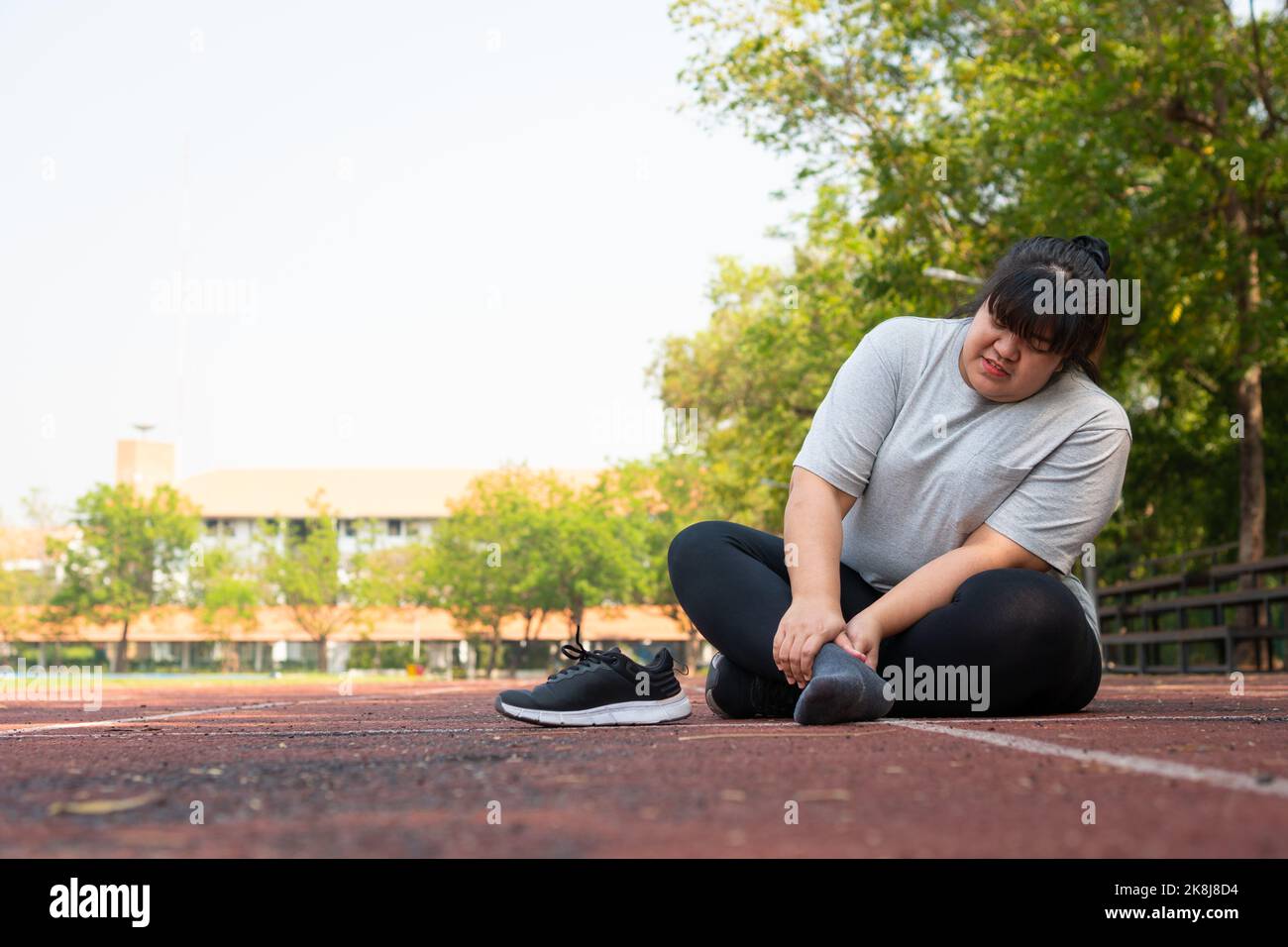 Asian overweight woman a new runner pain ankle during running, Athlete