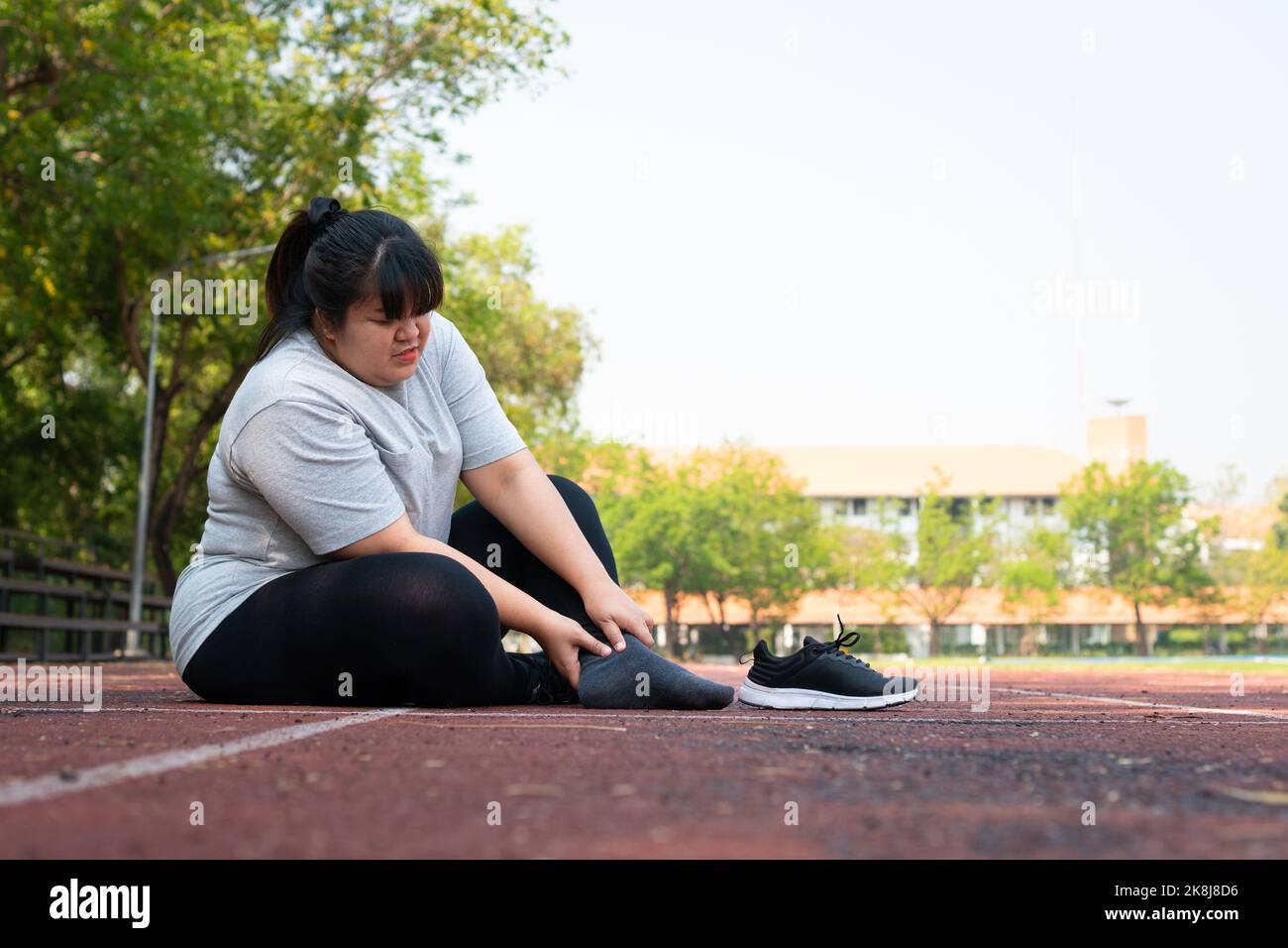 Asian overweight woman a new runner pain ankle during running, Athlete