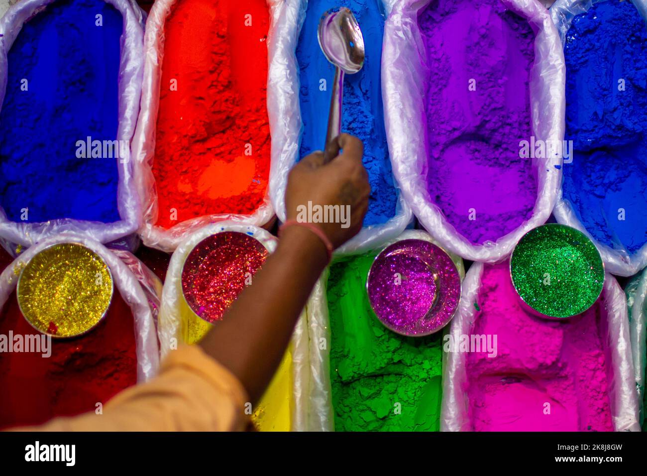Kathmandu, Nepal. 23rd Oct, 2022. A shopkeeper arranges pigments used