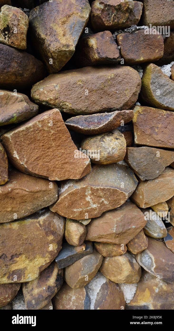 Beautiful background pattern image of a wall made of round stone red ...