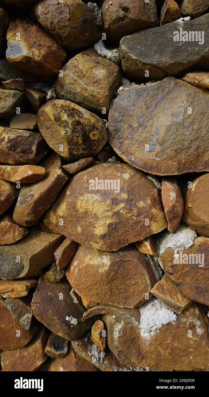 Beautiful background pattern image of a wall made of round stone red ...