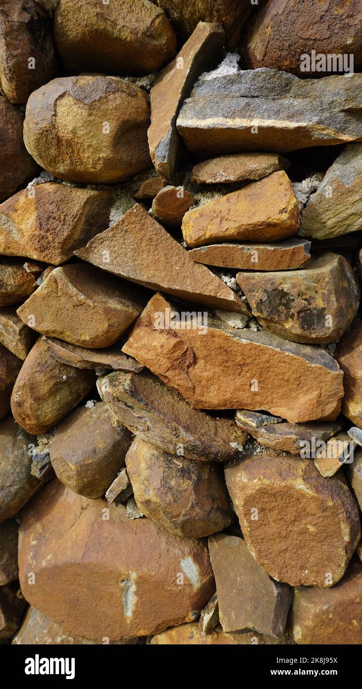 Beautiful background pattern image of a wall made of round stone red ...