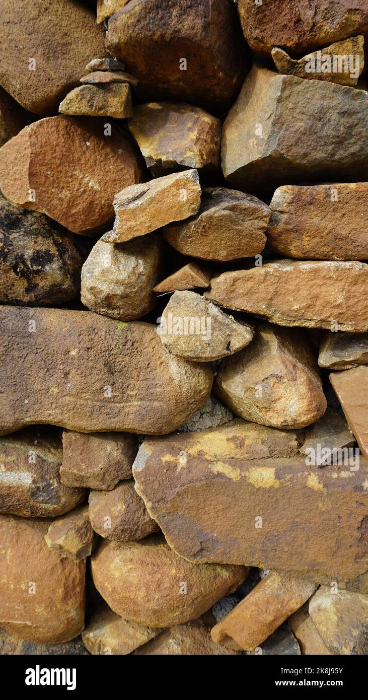 Beautiful background pattern image of a wall made of round stone red ...
