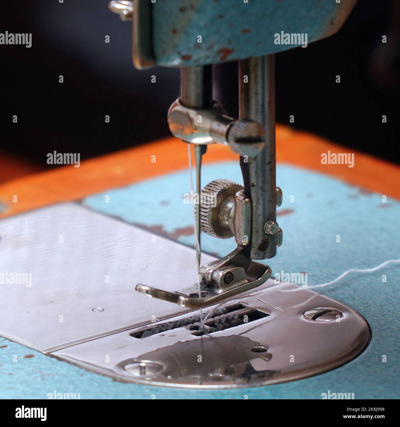 Sewing needle with thread on a sewing machine. Soft focus. Selective focus Stock Photo