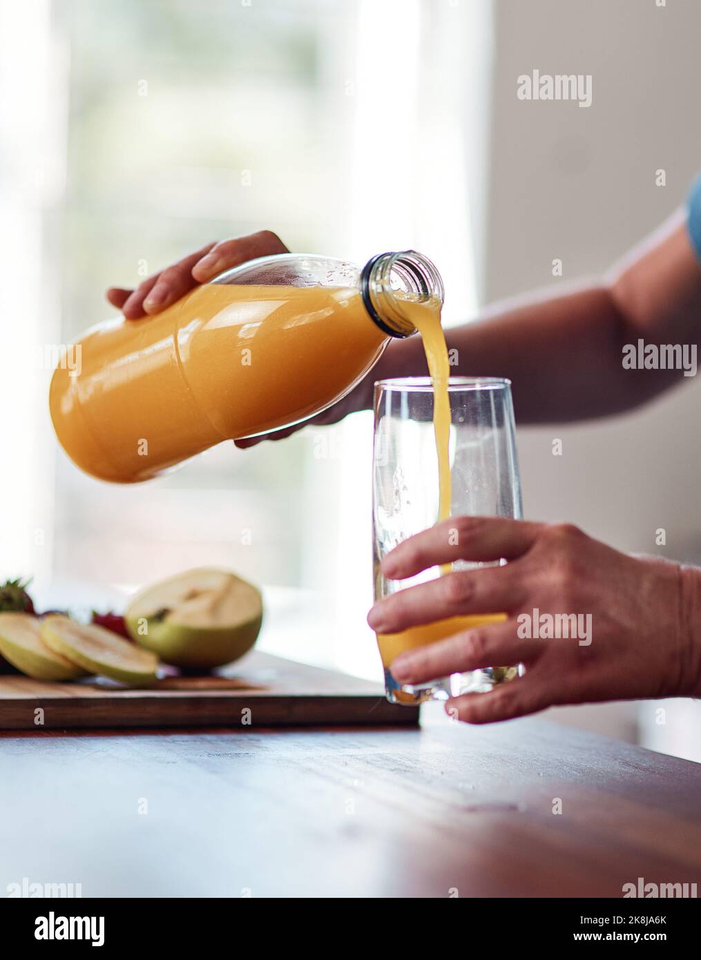 She loves her orange juice. an unrecognizable senior woman pouring