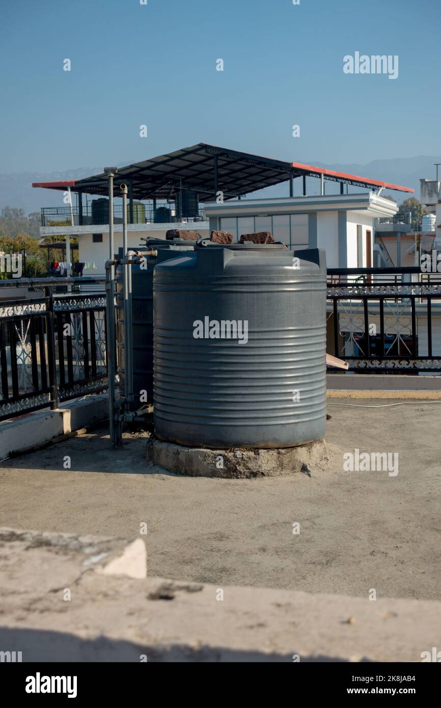 february 12th 2022, Dehradun City India. Big plastic water tanks on a roof top of a building in Urban area. Stock Photo