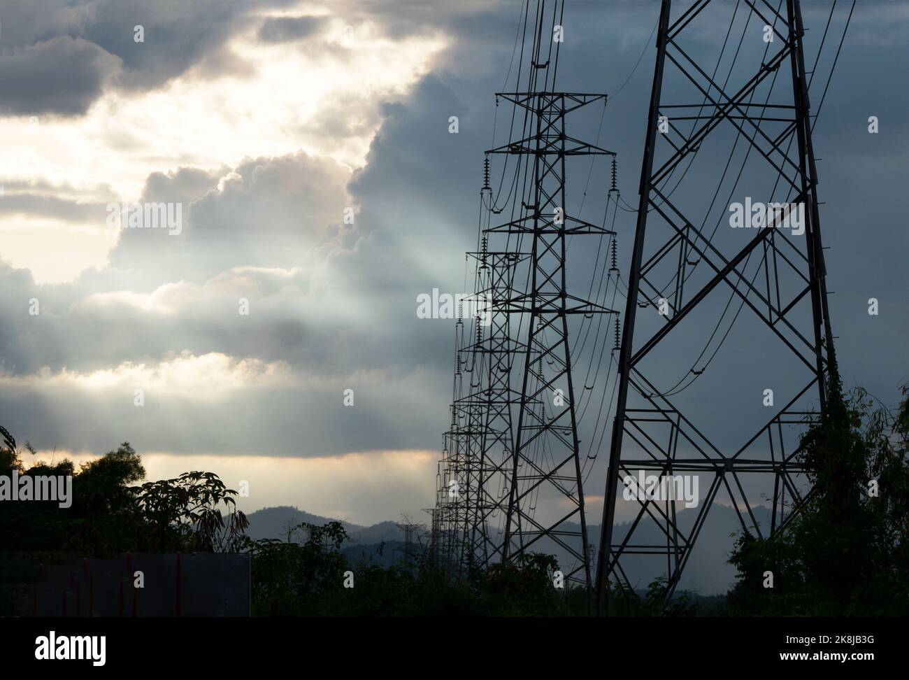 High voltage tower with power lines with Sunlight ray in the evening ...