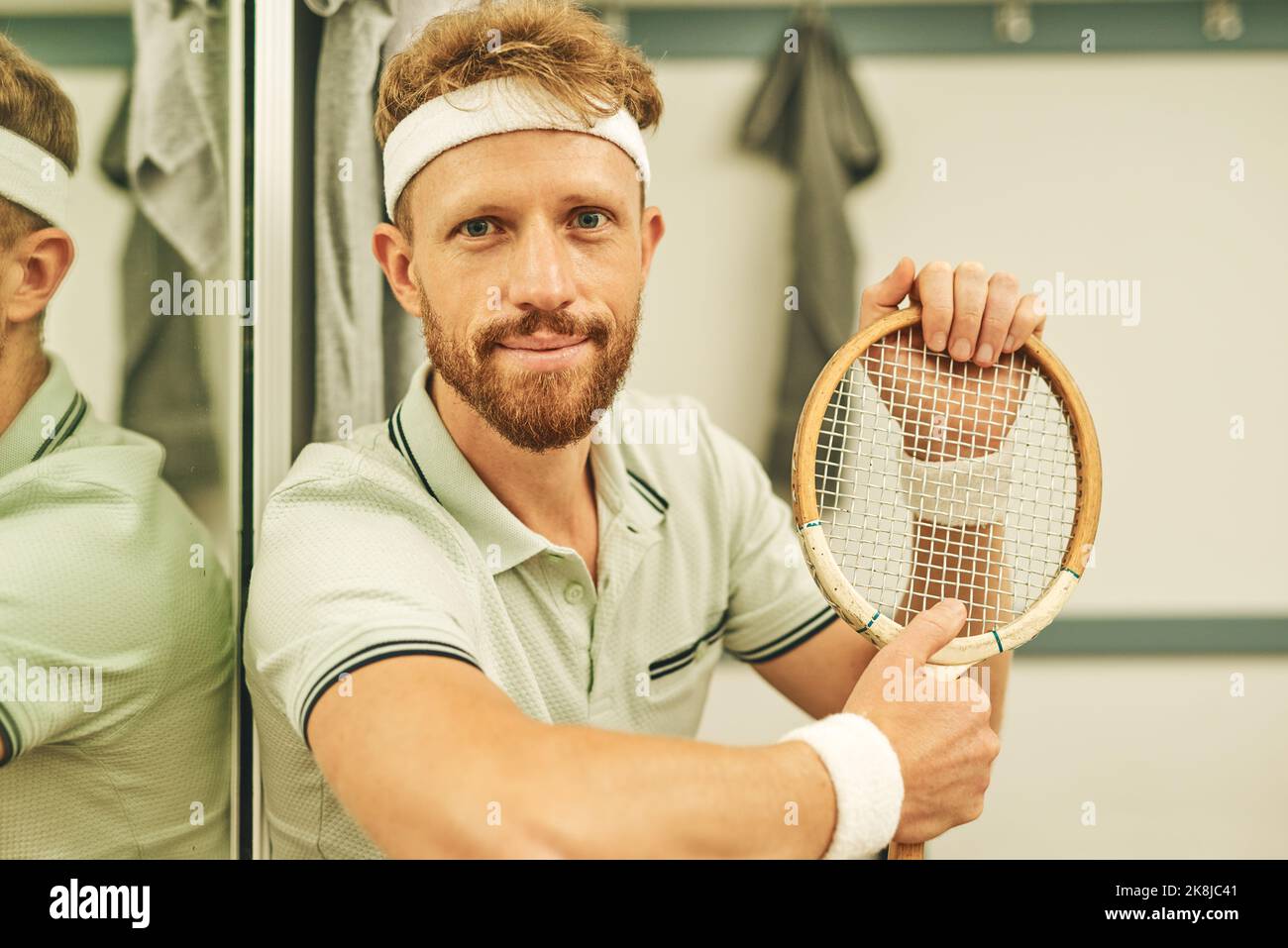 Seriously, is there any better sport. a young man in the locker room after a game of squash. Stock Photo