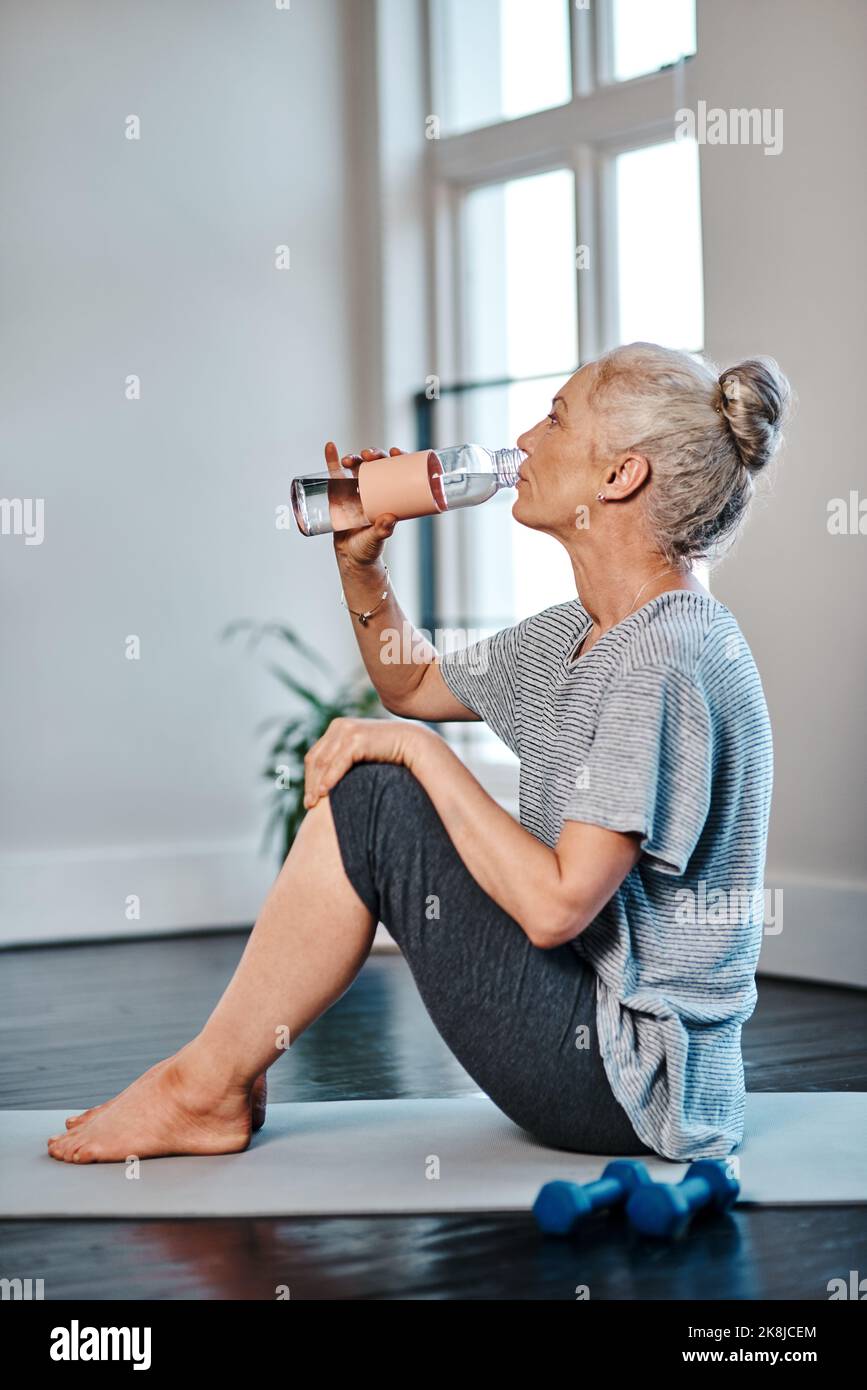 Cant have enough of the water. a mature woman practicing yoga while