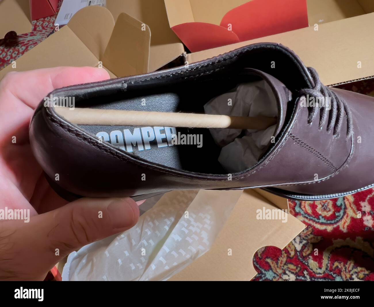 London, October 20, 2022 POV woman unboxing unpacking modern leather