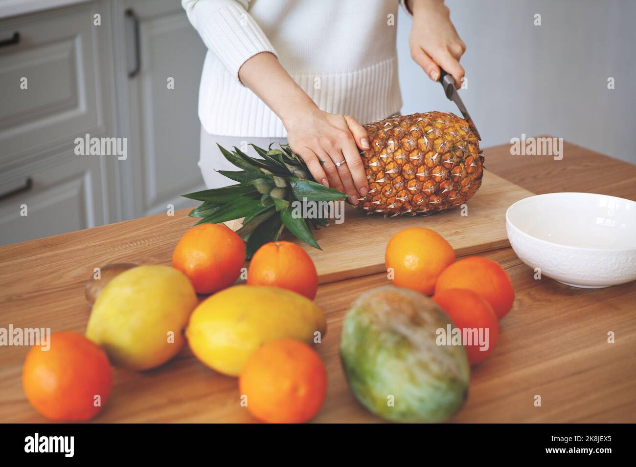 Girl hands cutting fruits on cutting board, close up shot. Healthy