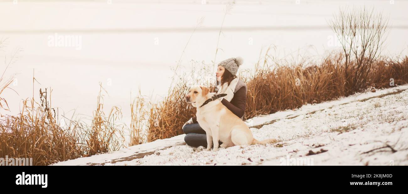 girl sits with his dog in the park and looks into the distance Stock ...