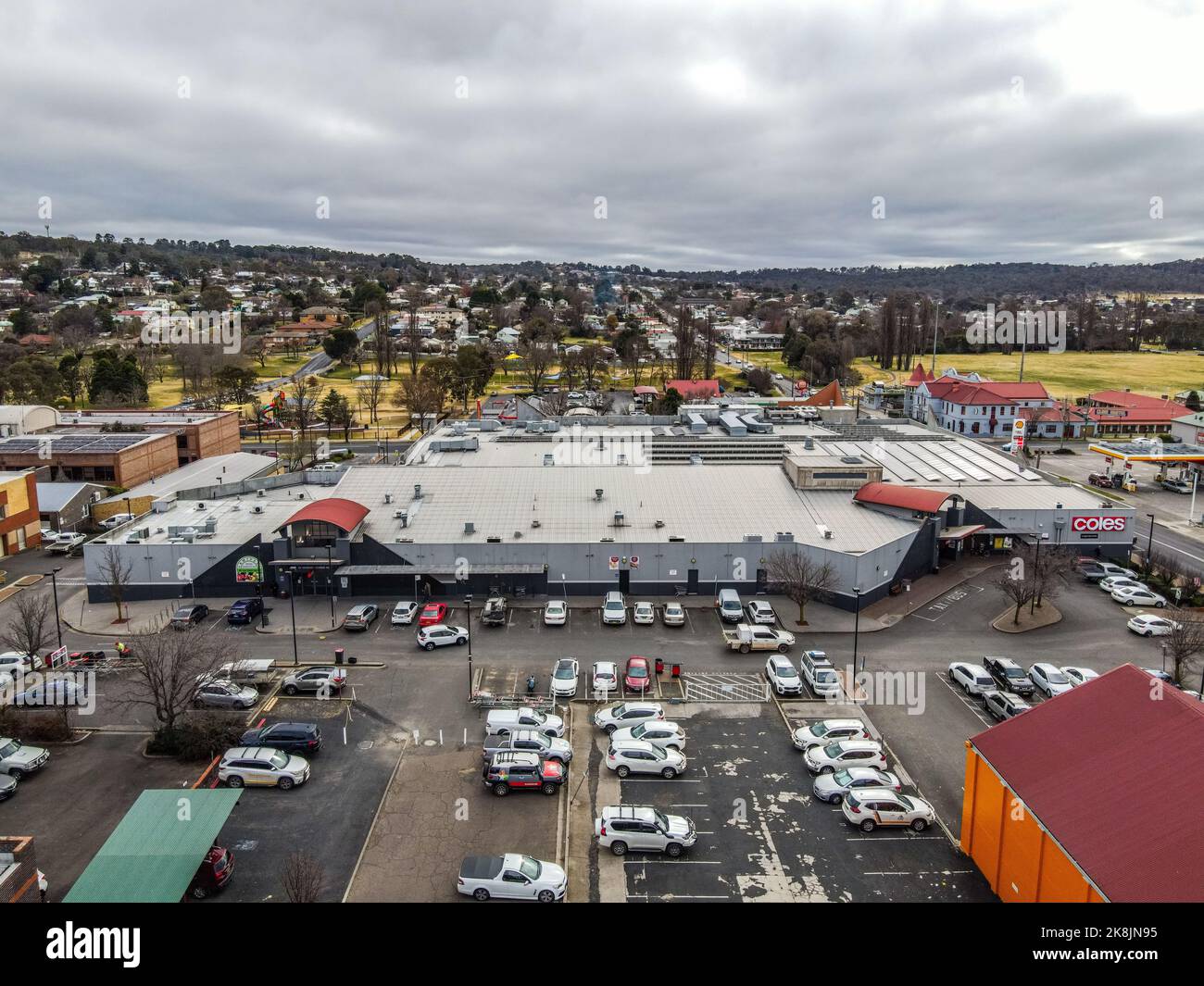 An aerial view of the town of Armidale with buildings and many parked ...