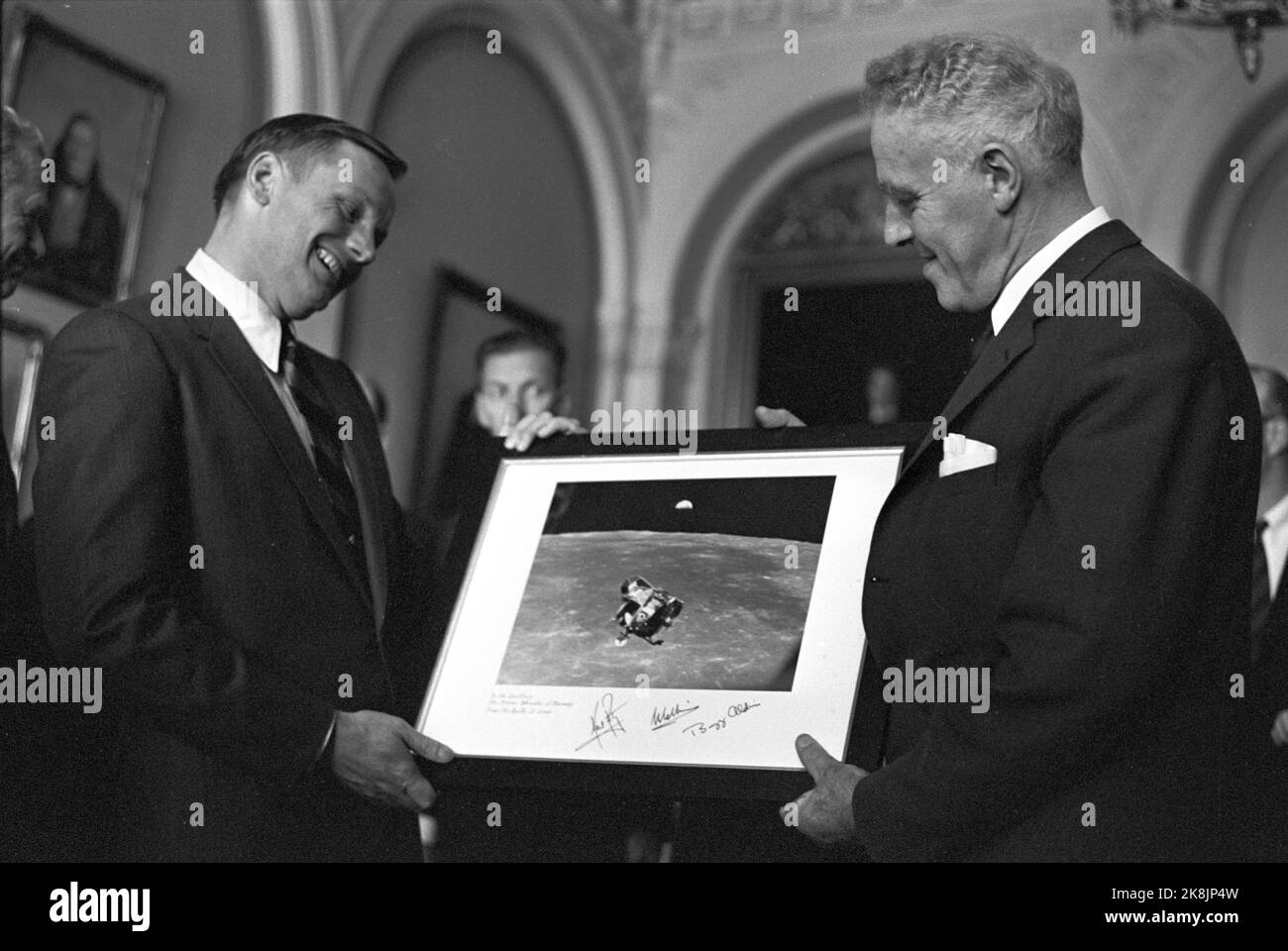Oslo 19691010 The American astronauts Buzz Aldrin, Neil Armstrong and Michael Collins from 'Apollo 11', which earlier that same year landed on the moon are on European tour. Here they visit the Storting, and Prime Minister Per Borten (Sp) (th) receives a picture of the 'Eagle' spacecraft with the earth in the background, from Astronaut Neil Armstrong. Photo: Aage Storløkken / Current / NTB Stock Photo