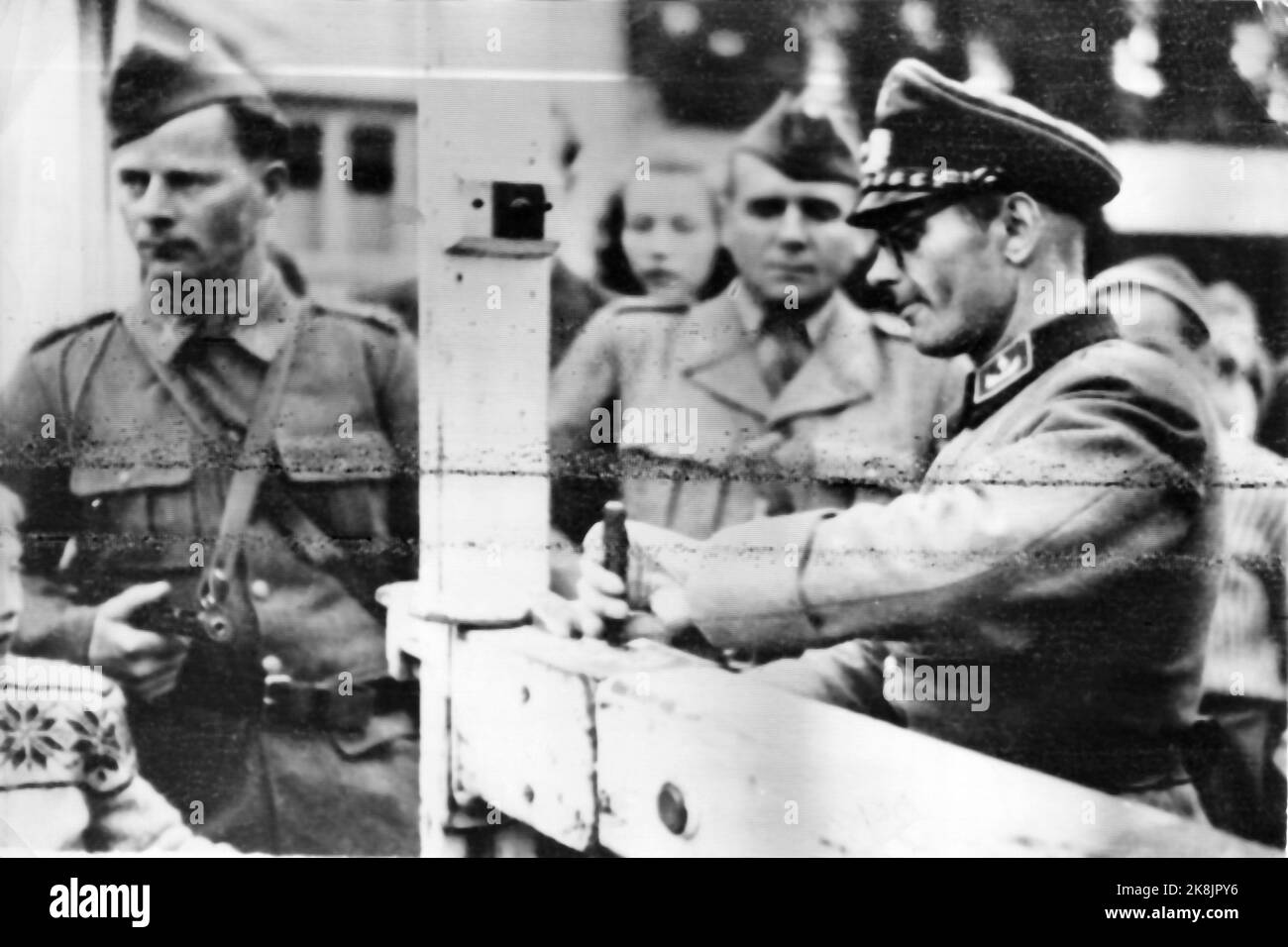 Border Norway / Sweden, 19450508 Capitulation: A German officer opens a border gate in the presence of a Swedish border guard. The picture was sent on Telepoto from Stockholm, so there are stripes and disturbances in the picture. Photo: NTB Archive / NTB Stock Photo