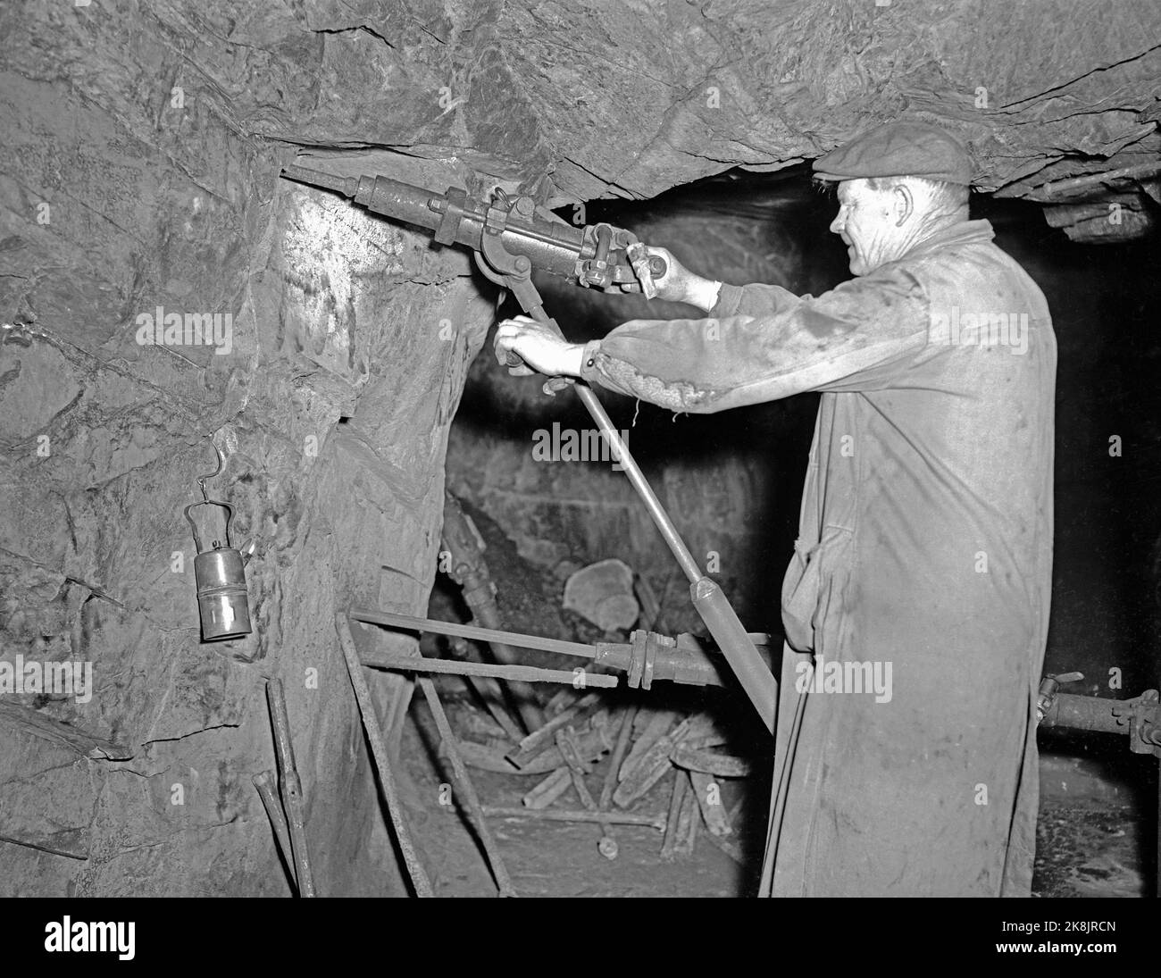 kongsberg 19550512 kongsberg slvverk photographed on may 12 1955 the mining company was established in 1623 and belongs to norways oldest and most well known mining the work is also considered norways largest company in pre industrial times and reached an extent of about 1000 km of mines 300 shafts and between 1500 and 2000 sharp kongsberg slvverk was in continuous operation until 1958 source wiki the picture miner drills in the mountains photo sv ntb 2K8JRCN