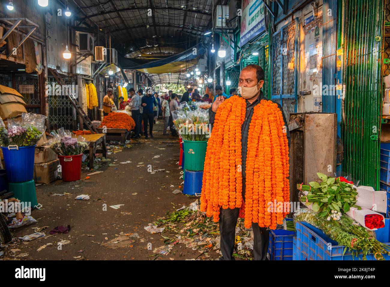 New Delhi, India. 24th Oct, 2022. A man seen carrying marigold garlands