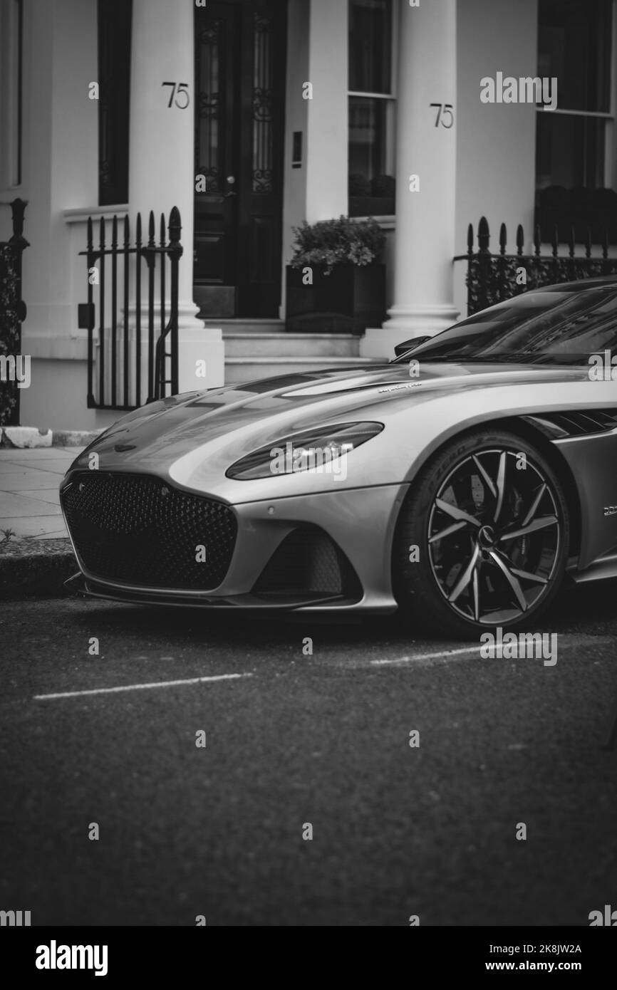 A vertical shot of an Aston Martin DBS parked in the streets of London Stock Photo