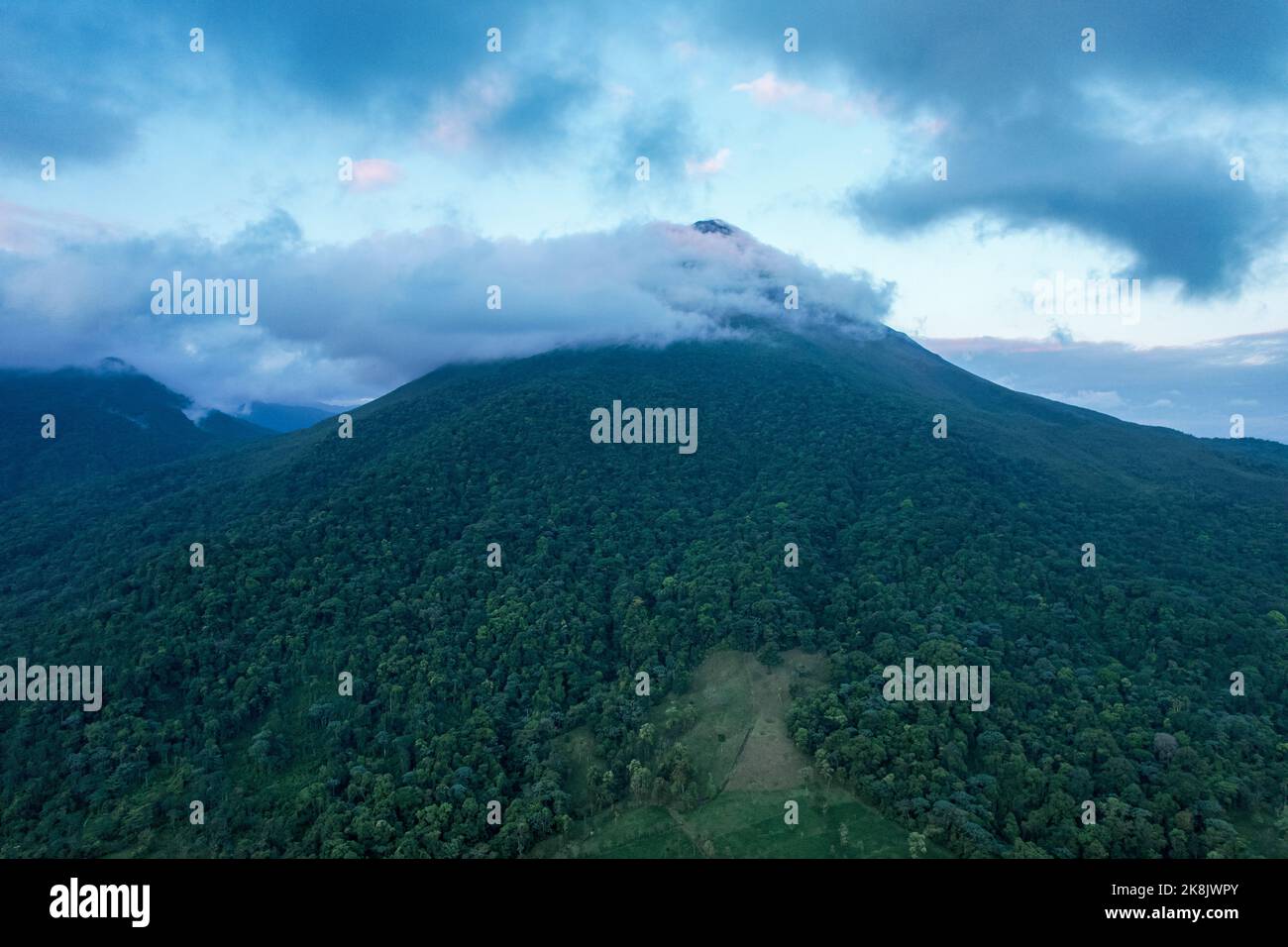 A beautiful mountain view with fog surrounding its top Stock Photo - Alamy