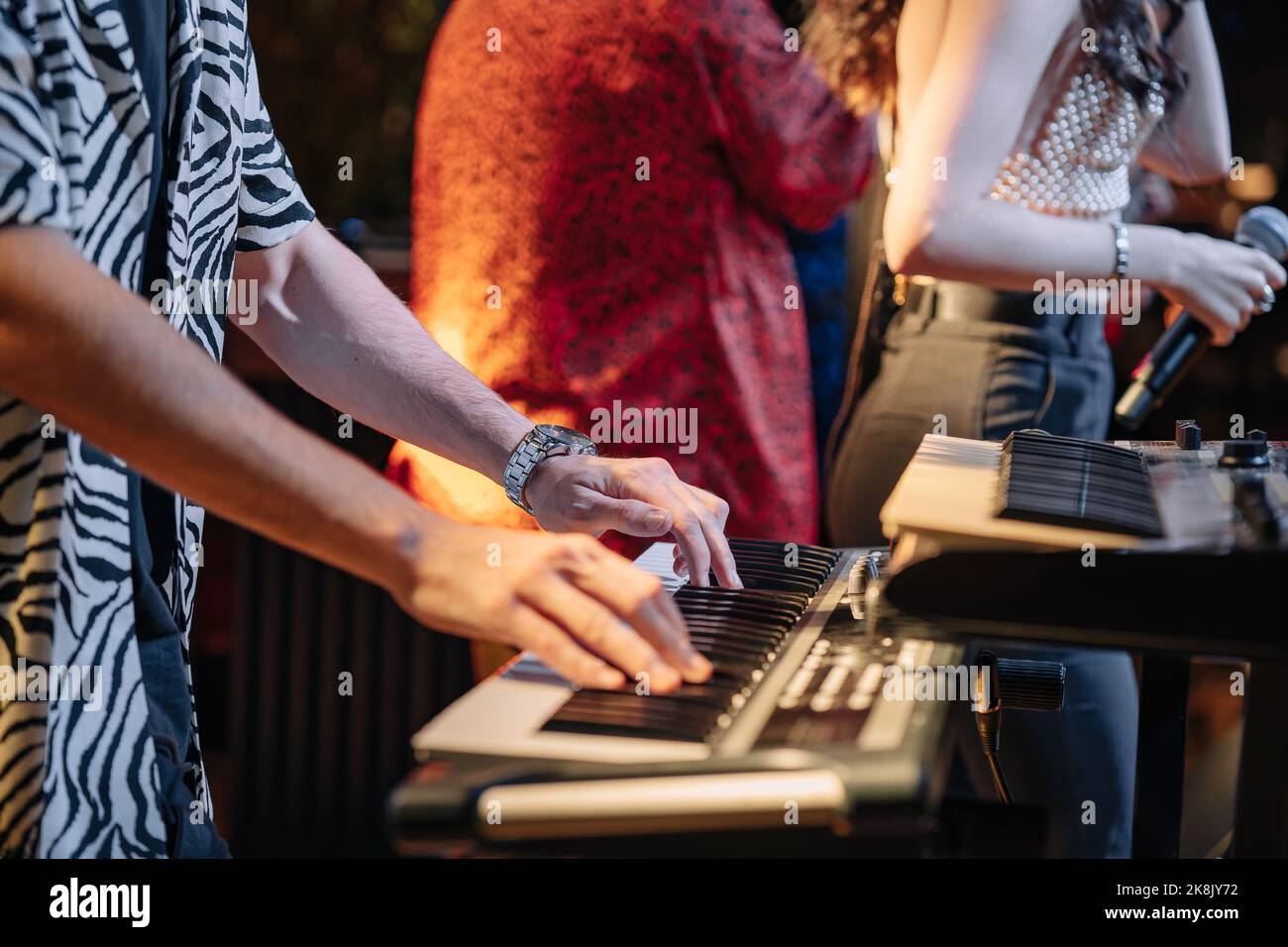 Close up of a keyboardist musician at work at a concert. Keyboardist