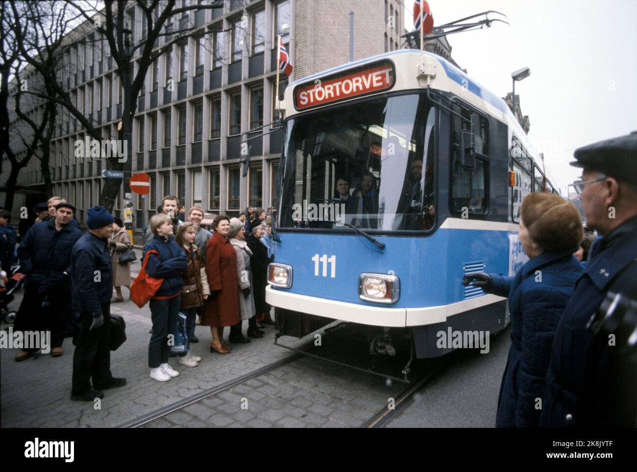 Oslo 1983-03: Last tram on Karl Johan. Restructuring of the tram routes in Oslo. The tram goes here for the last time (last day) up through Karl Johans gate in downtown Oslo, March 23, 1983. Here the tram passes, for the occasion decorated with the Norwegian flag, the Storting and Egertorget. Photo: Henrik Laurvik / NTB Stock Photo