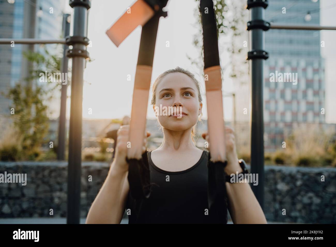 Young woman doing exercises at outdoor work-out city park. Stock Photo