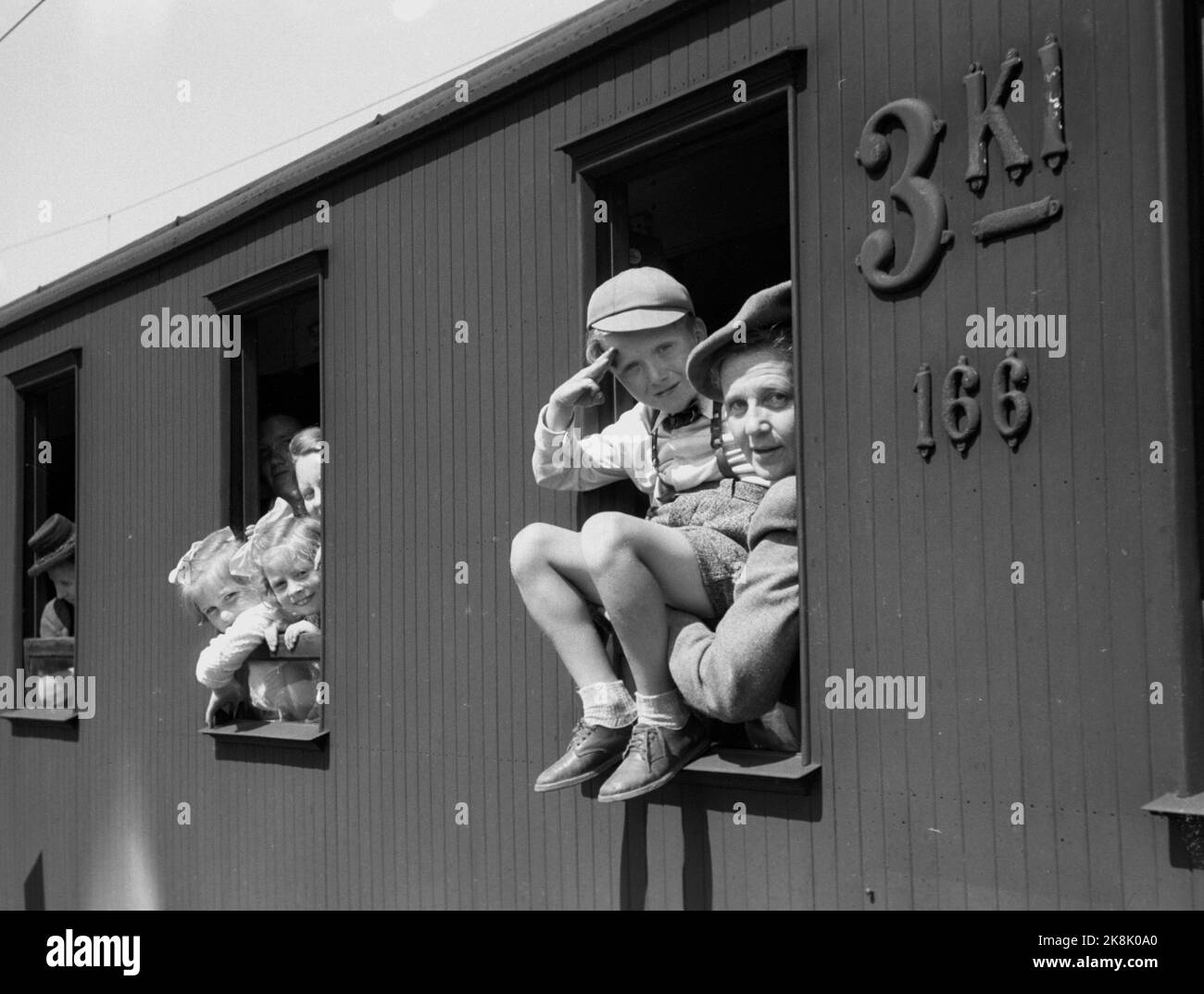 Oslo 19460713. The fight to come on vacation is hard. Norwegian People's Aid has this summer arranged free holiday stays for tired housewives at Lauvåsen in Gudbrandsdalen. Here we see mother and children on the train on the East Railway looking forward to the holidays. Photo: Thorbjørn Skotaam / Current / NTB Stock Photo