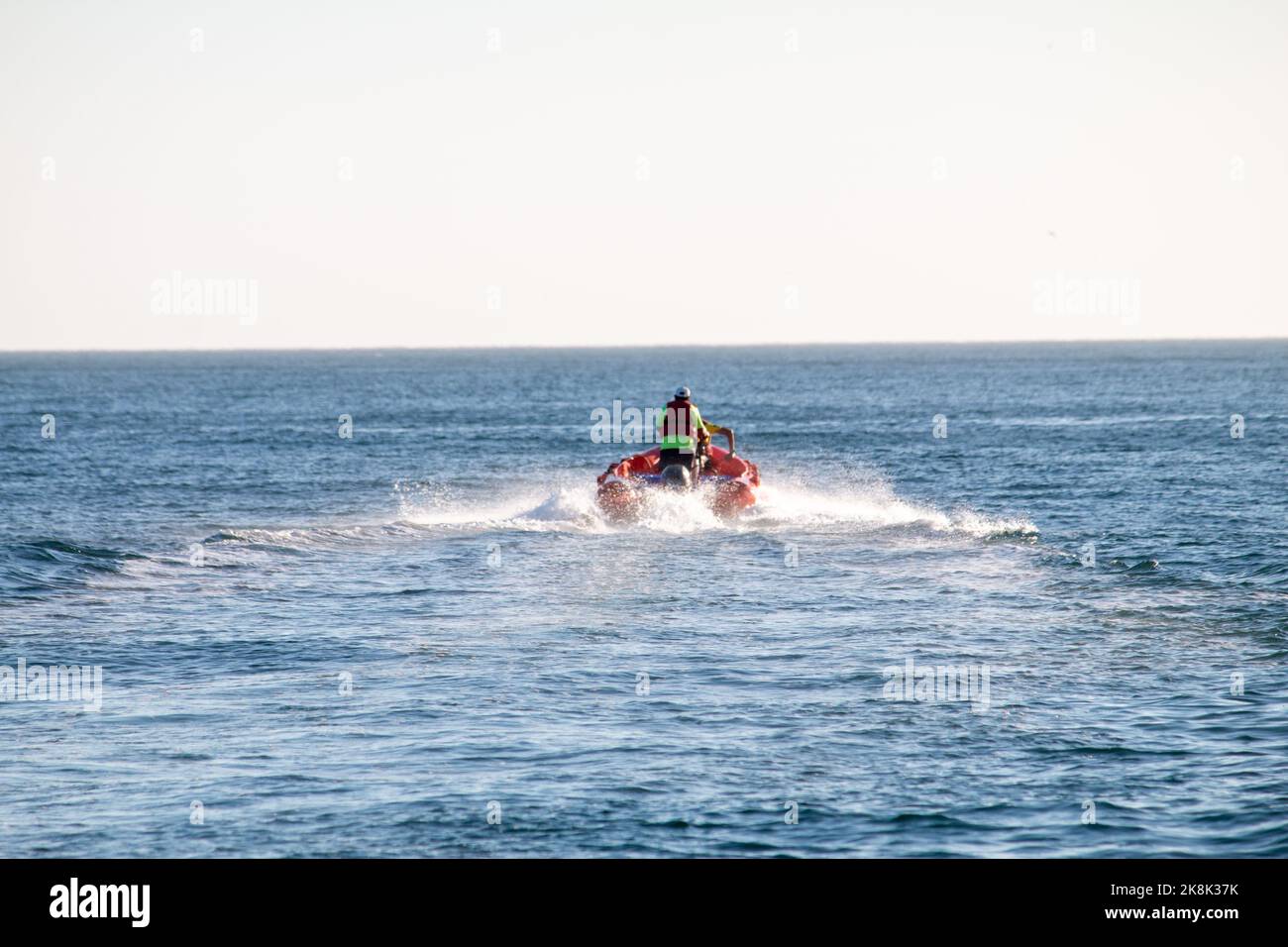 A man with a motorboat in the ocean Stock Photo - Alamy