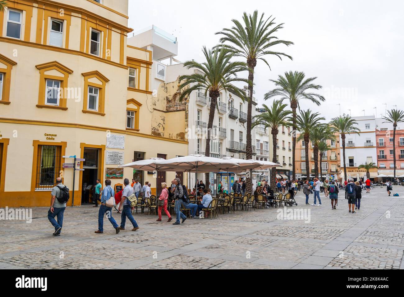 Visitors on a terrace in a street in Cadiz, Andalusia, Costa de la luz, Spain. Stock Photo
