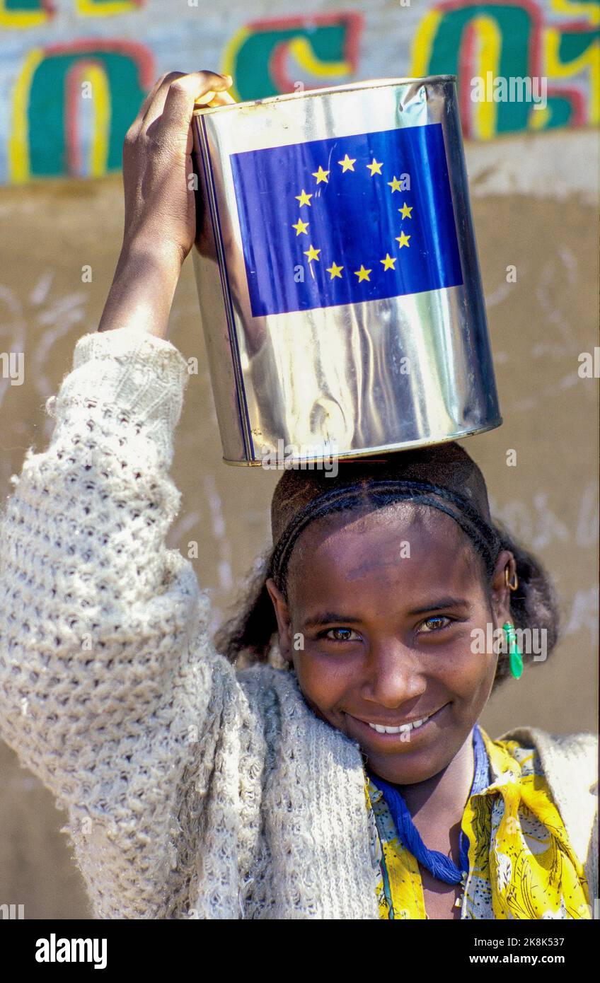 Ethiopia, Tigray; girl with a can with cooking oil provided by a
