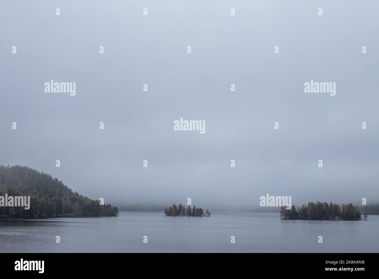 A landscape with a lake on a foggy day Stock Photo - Alamy