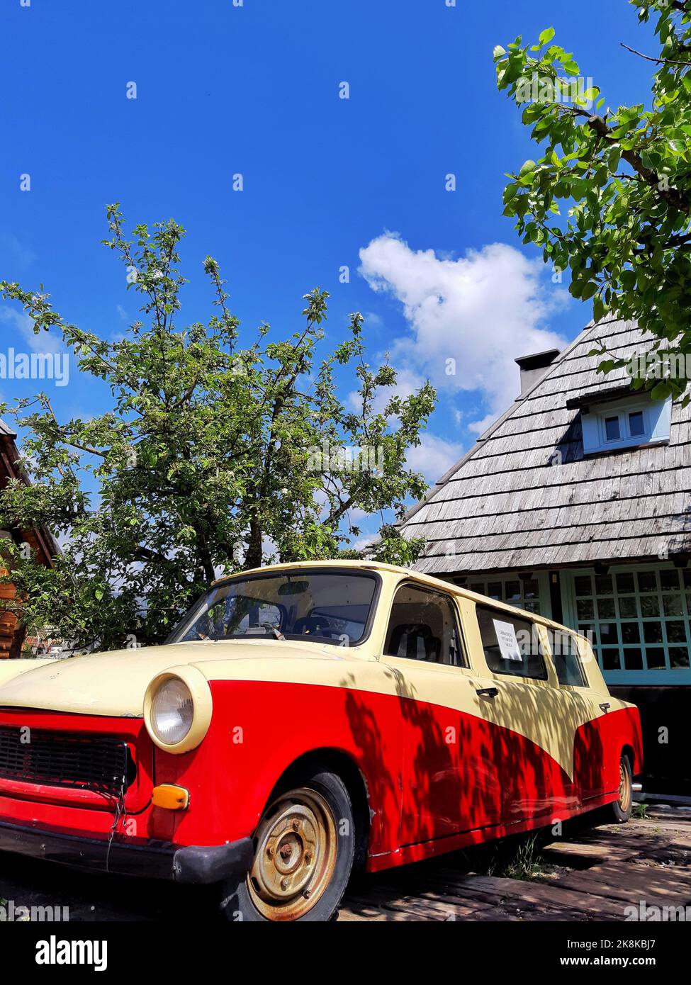 An old, vintage Trabant 601 parked in front of a house, vertical Stock Photo