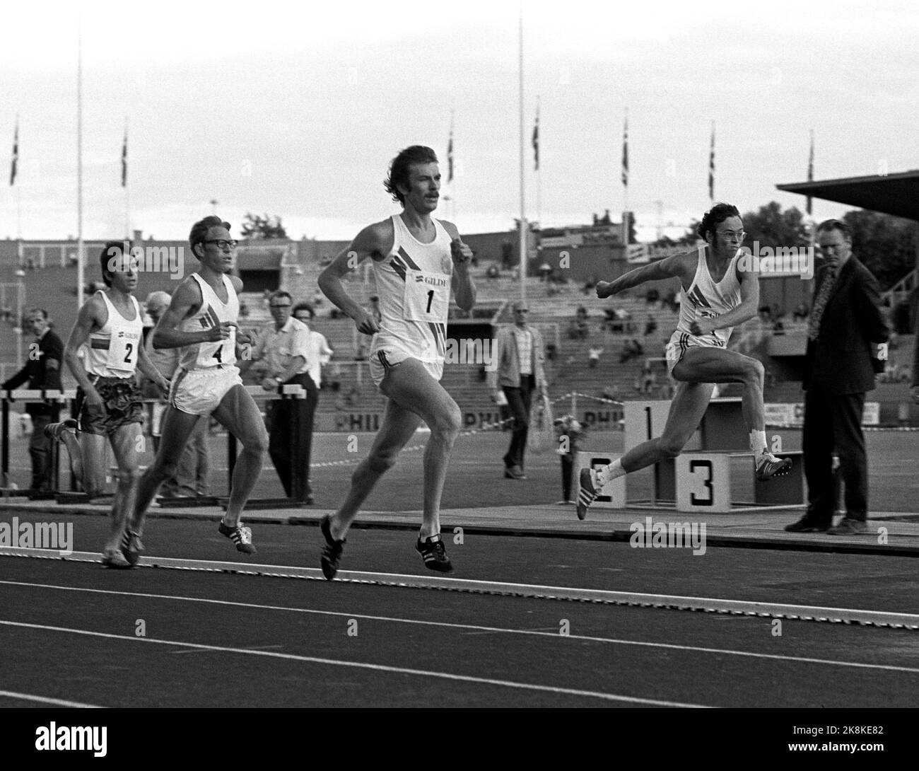 Oslo 197407. Athletics match between Norway, Scotland and Bulgaria at Bislett Stadium. The picture shows two winners in action: t.h. Takes Kristen Fløgstad's SATS in three steps, while Knut Kvalheim leads at 5000 m. Just behind Kvalheim is Arne Risa. Photo Arild Hordnes / NTB / NTB Stock Photo