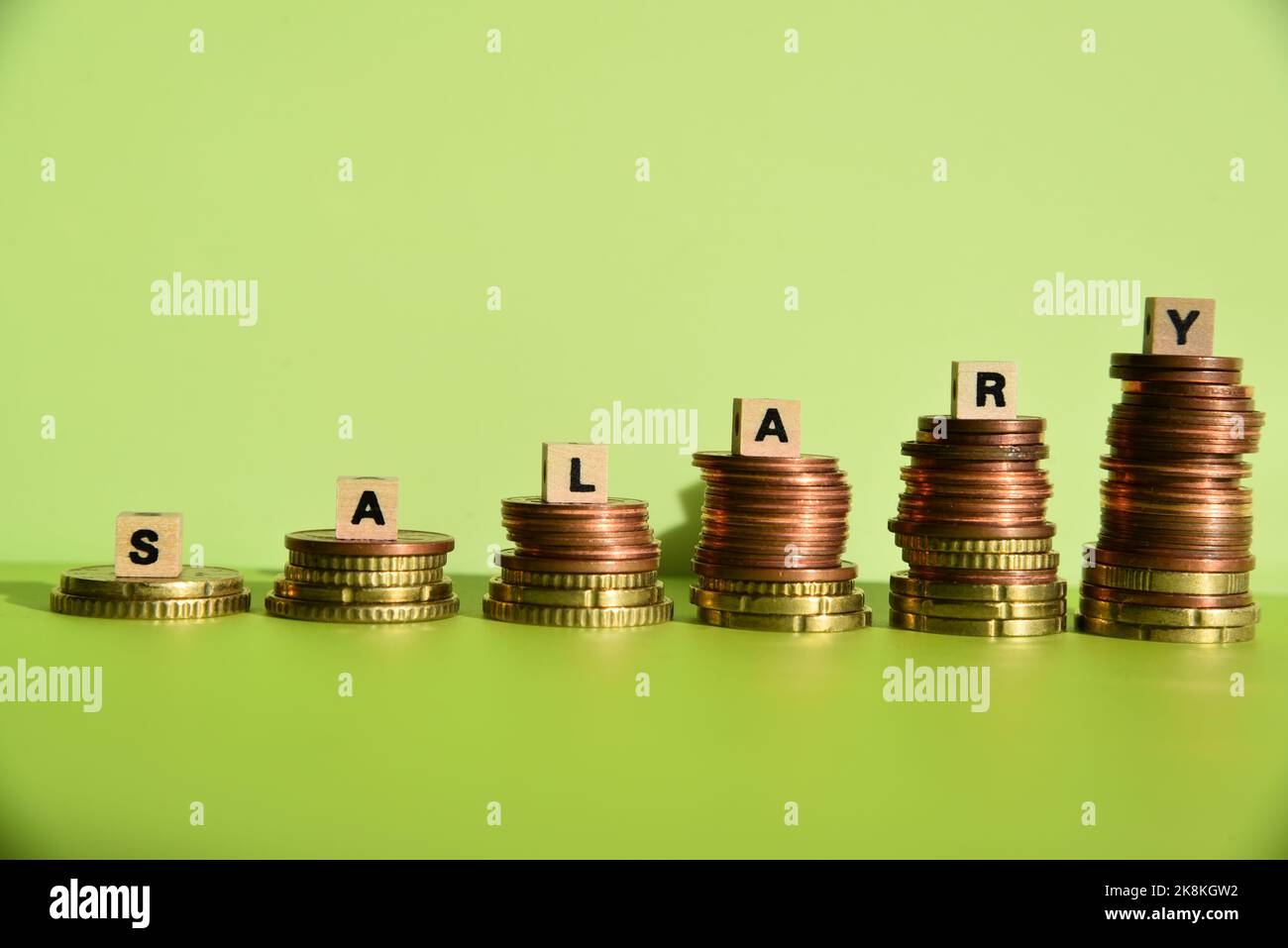 Salary and coin stacks Stock Photo