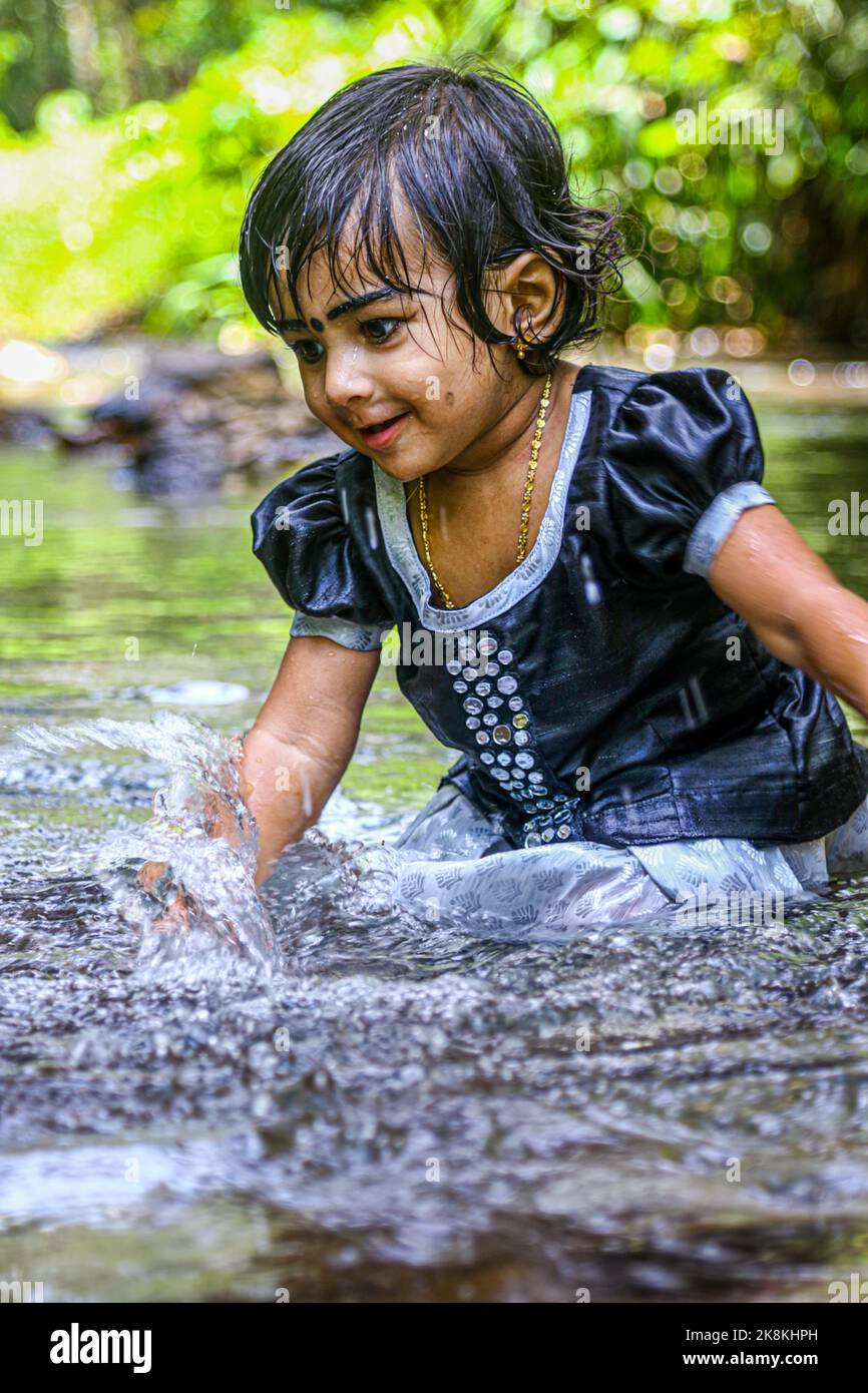 A baby girl bathing in the river Stock Photo Alamy